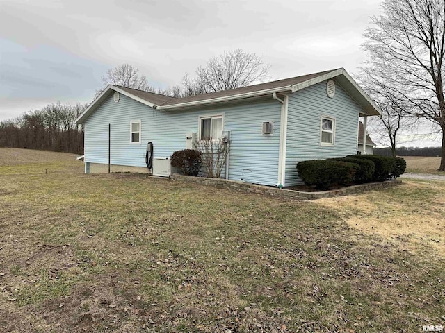 view of side of property with a lawn