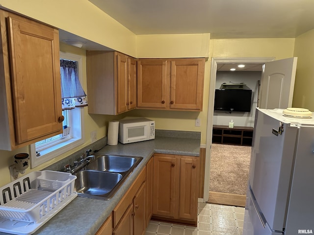 kitchen with sink and white appliances