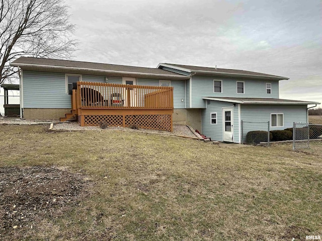 rear view of property with a wooden deck and a yard