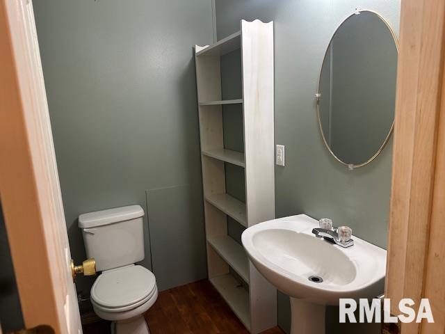 bathroom featuring hardwood / wood-style flooring, toilet, and sink