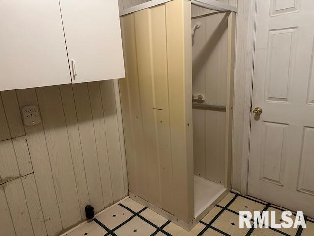 bathroom featuring wood walls