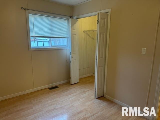 unfurnished bedroom with light wood-type flooring