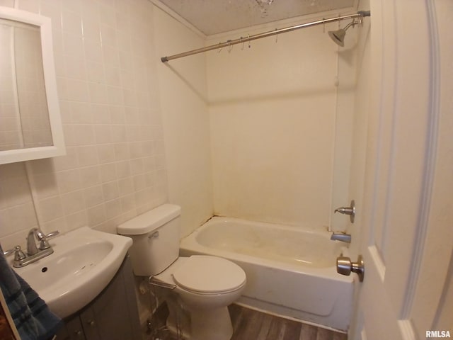 520 Dewey St, Eldorado, IL 62930 - full bath with shower / bathing tub combination, vanity, tile walls, toilet, and wood finished floors
