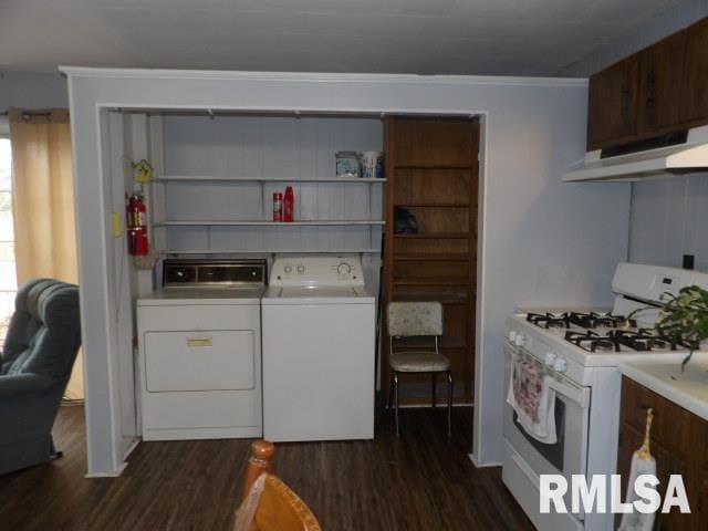 laundry room with dark wood-type flooring and separate washer and dryer