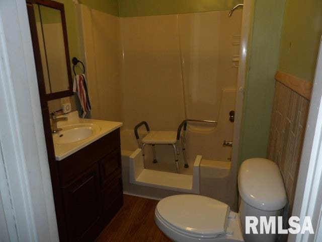 bathroom with vanity, hardwood / wood-style flooring, and toilet