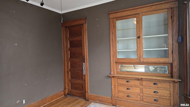 interior space with crown molding and light wood-type flooring