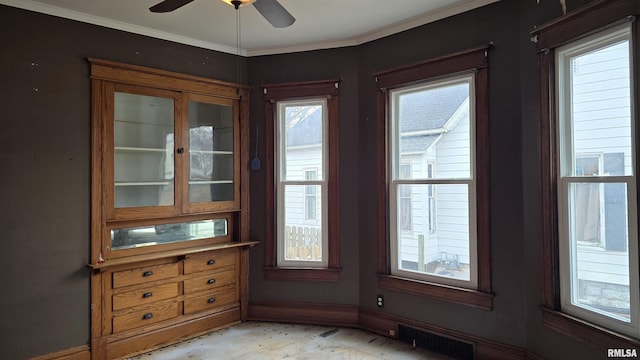 interior space with crown molding and ceiling fan