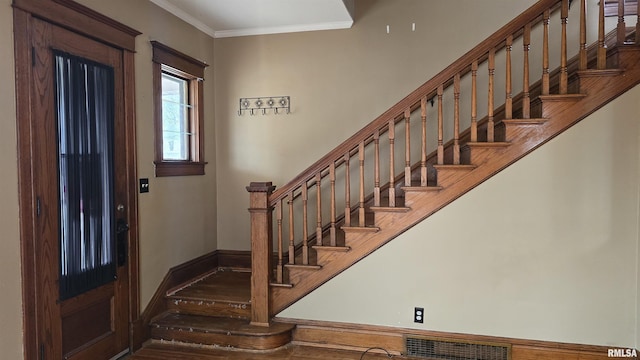 entrance foyer featuring crown molding