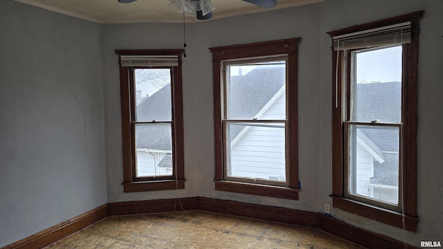 unfurnished room with a wealth of natural light and ceiling fan