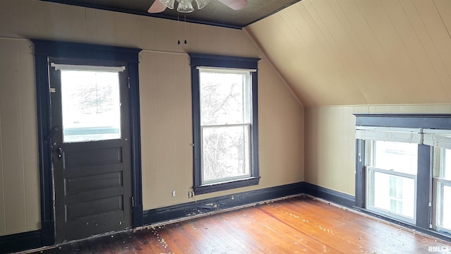 bonus room with dark wood-type flooring, a healthy amount of sunlight, and vaulted ceiling