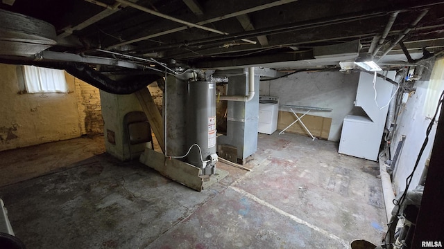 basement featuring washer / dryer, gas water heater, and fridge