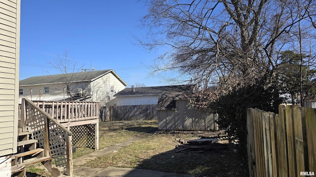 view of yard with a wooden deck and a shed