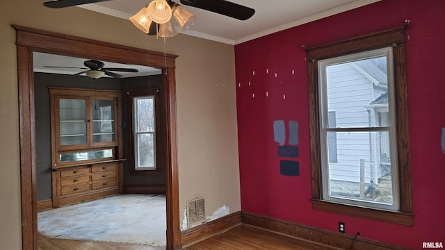 doorway to outside with ceiling fan, ornamental molding, and hardwood / wood-style floors