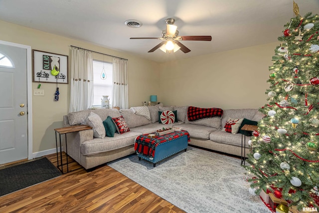 living room with wood-type flooring and ceiling fan