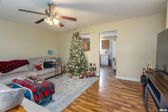 living room featuring hardwood / wood-style floors and ceiling fan