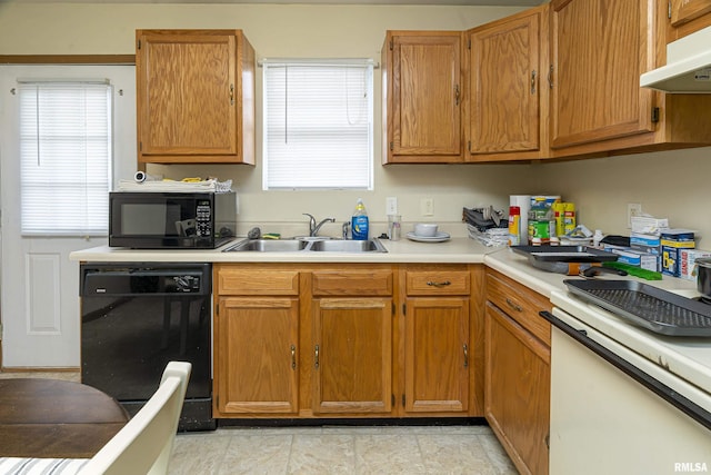 kitchen featuring a healthy amount of sunlight, sink, and black appliances