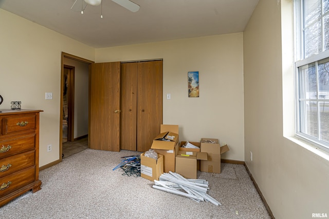 interior space featuring light carpet, a wealth of natural light, and ceiling fan