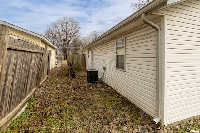 view of side of property with central air condition unit