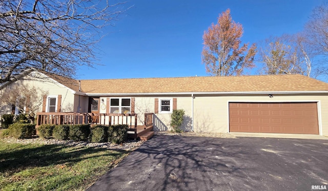 ranch-style house featuring a wooden deck and a garage