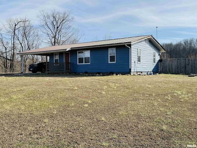 view of front facade with a front lawn and a carport