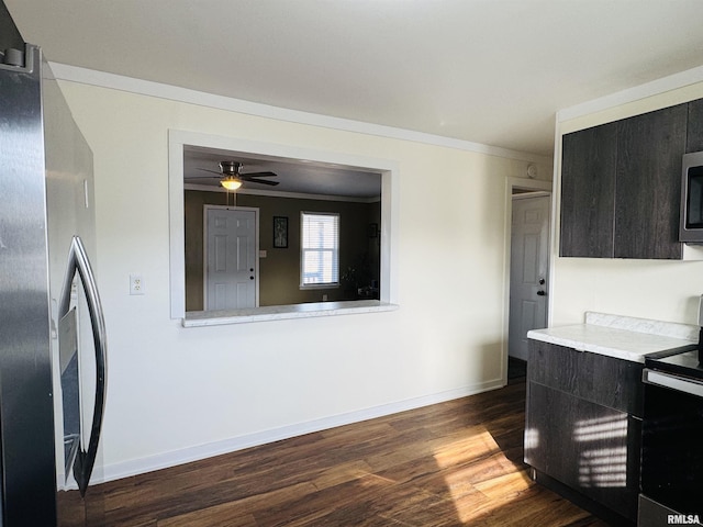 kitchen featuring ornamental molding, dark wood-type flooring, stainless steel appliances, and ceiling fan