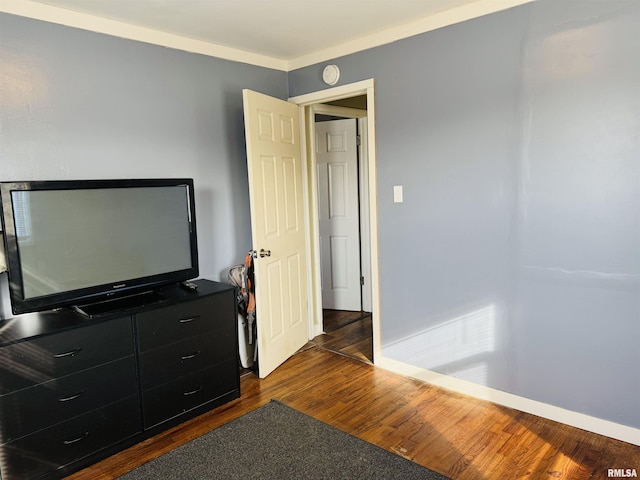 bedroom with dark hardwood / wood-style floors