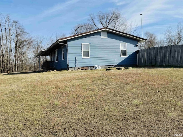 view of side of property with a yard