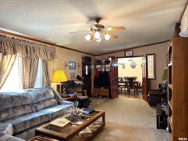 carpeted living room with a textured ceiling, ornamental molding, and ceiling fan