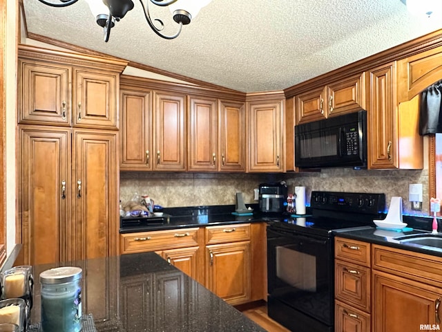 kitchen featuring sink, decorative backsplash, black appliances, and a textured ceiling