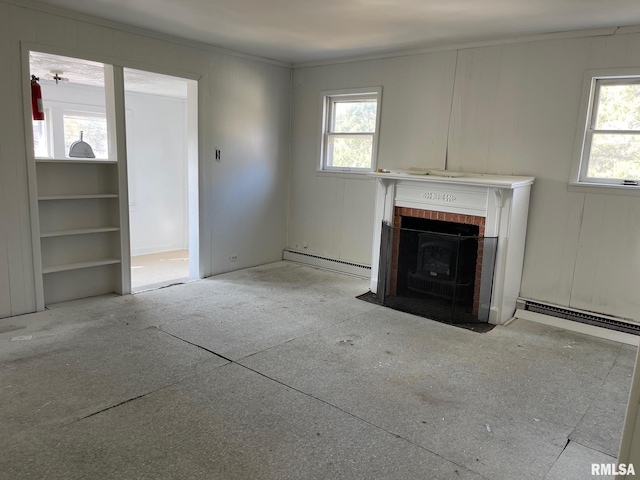 unfurnished living room featuring a wealth of natural light, ornamental molding, and baseboard heating