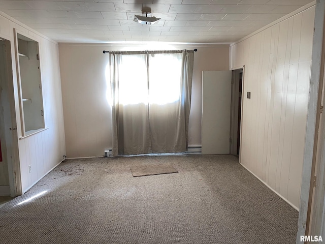 carpeted empty room featuring crown molding