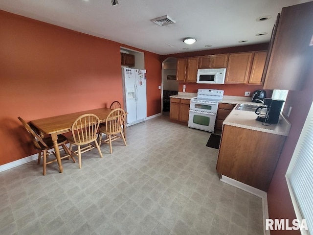 kitchen featuring sink and white appliances