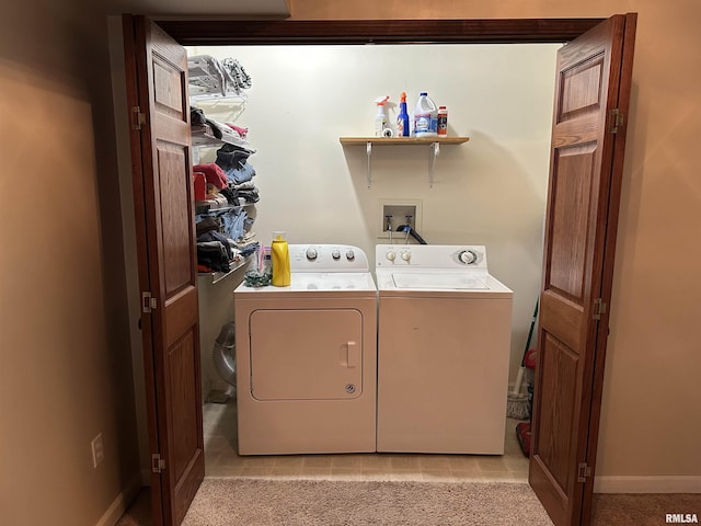 laundry room with washing machine and dryer and light carpet