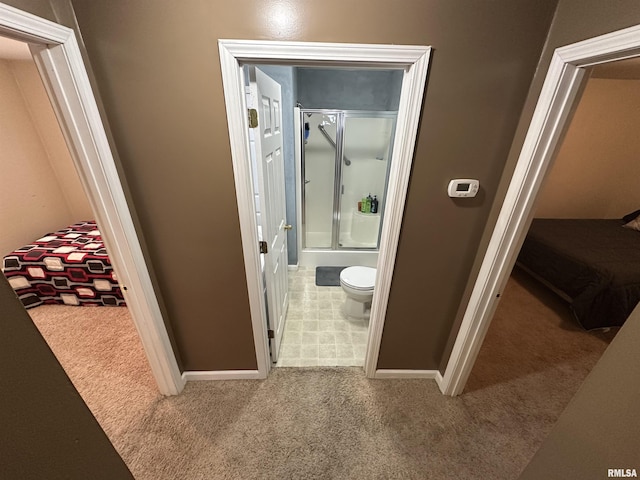 bathroom featuring shower / bath combination with glass door and toilet