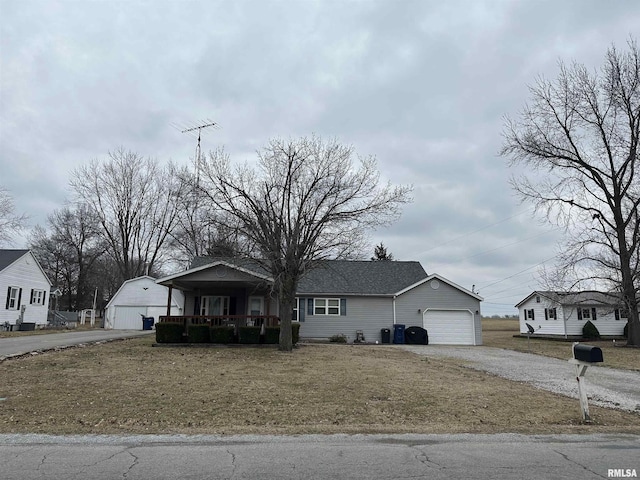 view of front of property featuring a porch, a garage, and a front lawn