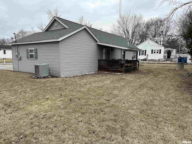 view of home's exterior with central AC unit and a yard