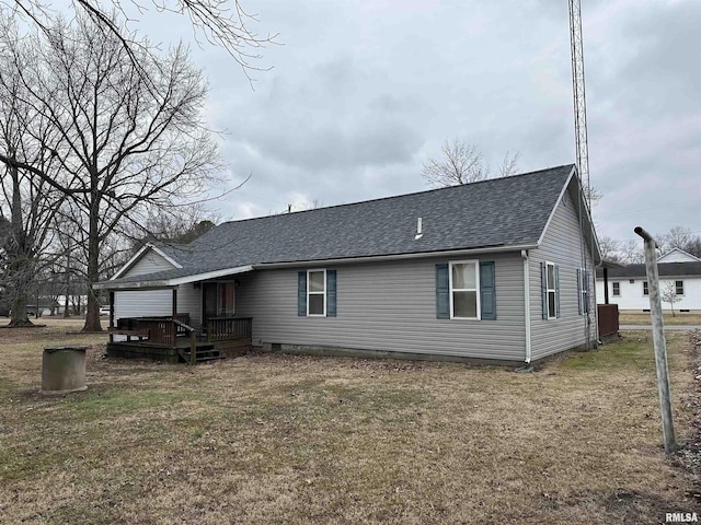 rear view of house featuring a lawn