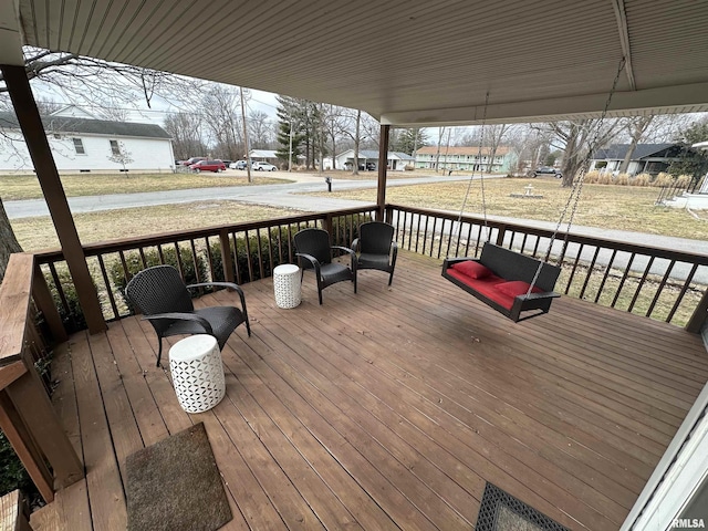 wooden deck with a lawn