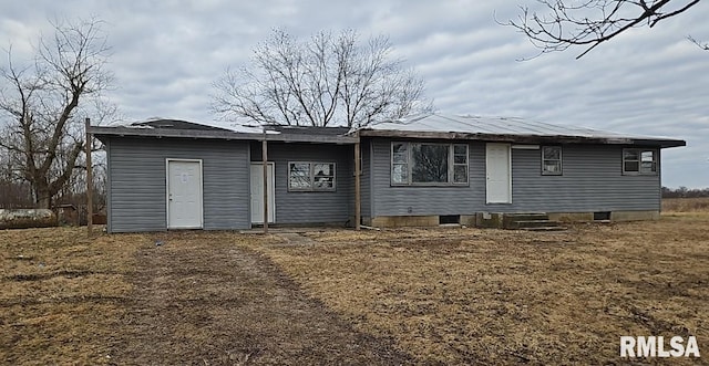 rear view of property featuring a yard