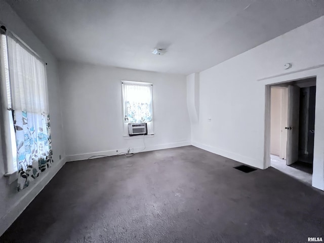 unfurnished room featuring cooling unit