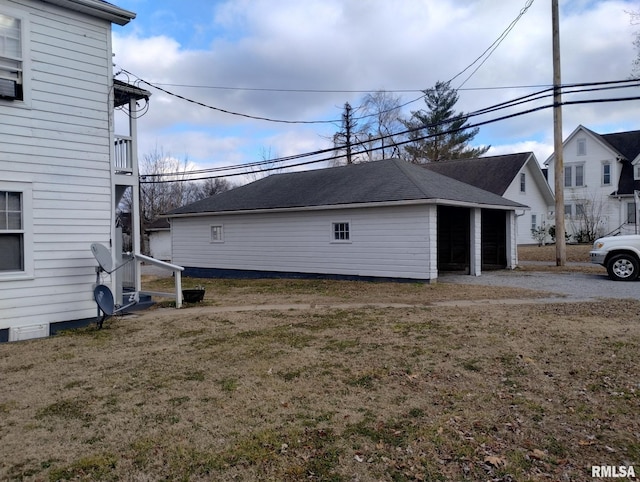 view of home's exterior featuring an outdoor structure and a lawn