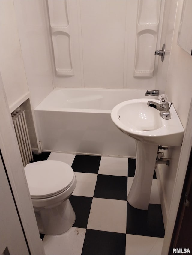 bathroom featuring washtub / shower combination and toilet