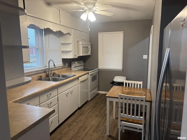 kitchen featuring white cabinetry, white appliances, dark hardwood / wood-style flooring, and sink