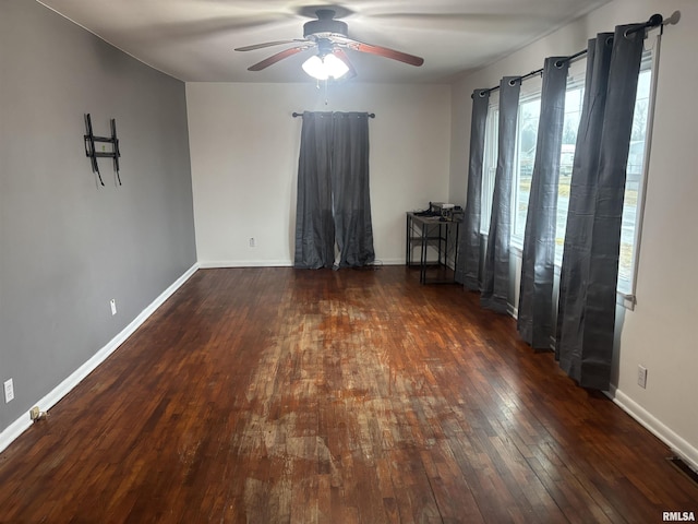 empty room featuring ceiling fan and dark hardwood / wood-style flooring