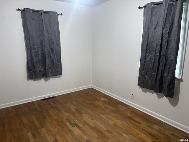 spare room with dark hardwood / wood-style flooring