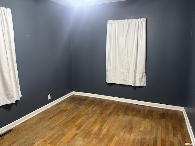 spare room with wood-type flooring