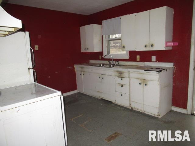 kitchen with ventilation hood, sink, white cabinets, white fridge, and range