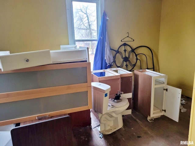 interior space with wood-type flooring and toilet