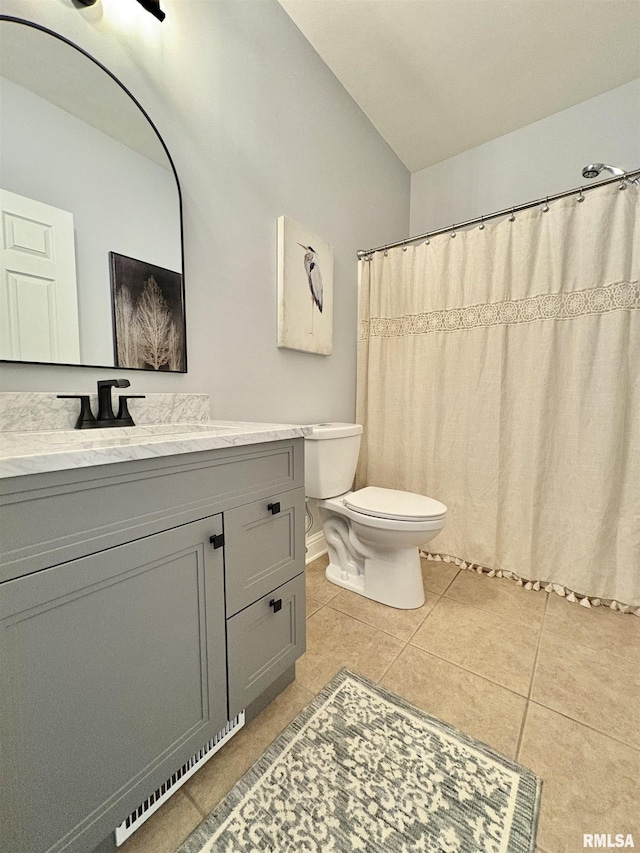 bathroom with tile patterned floors, vanity, and toilet