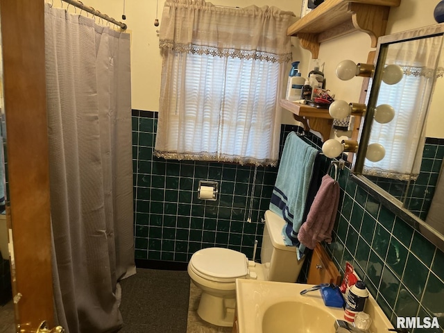 bathroom featuring sink, tile walls, curtained shower, and toilet